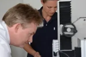 Engineers using a microscopes for process development